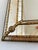 A large vintage Spanish Venetian-style rectangular beveled wall mirror, dating to the 1980s. The mirror has a decorative...