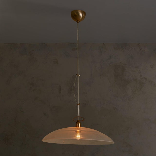 A 1970s Italian pendant in blown Murano glass, suspended from its original brass canopy with adjustable tension wires. The...