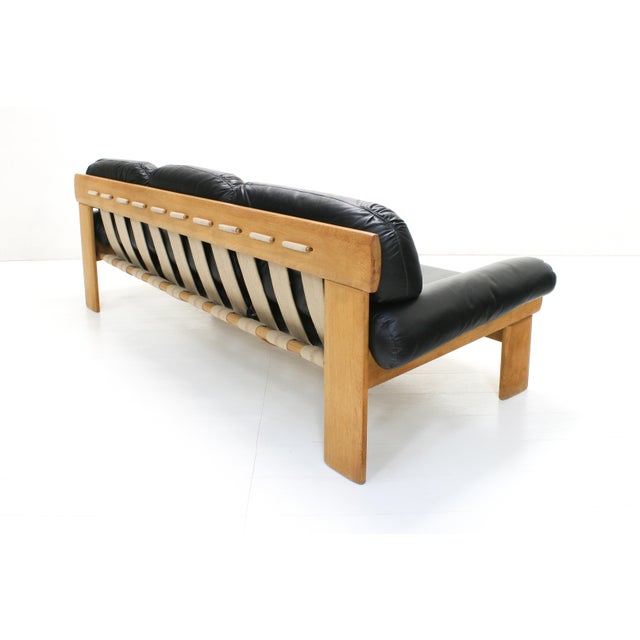 This sofa by Esko Pajamies for Asko, Finland was produced in the 1970s. A brutalist style oak frame with burlap straps...