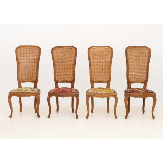 Set of Five Italian Provincial Style Cane-Paneled Walnut Dining Chairs, four side chairs and one armchair, each with high...