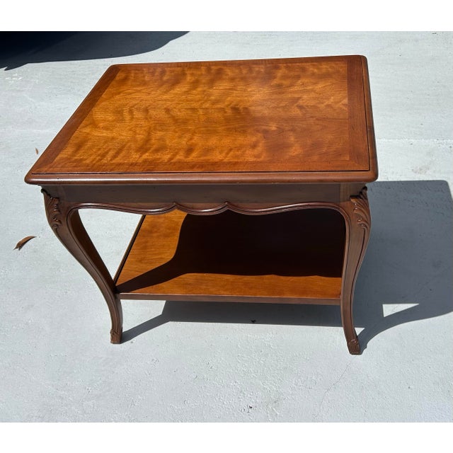 This is an elegant pair of French Provincial style nightstands by Henredon. Features: -Gorgeous finish on top surface...