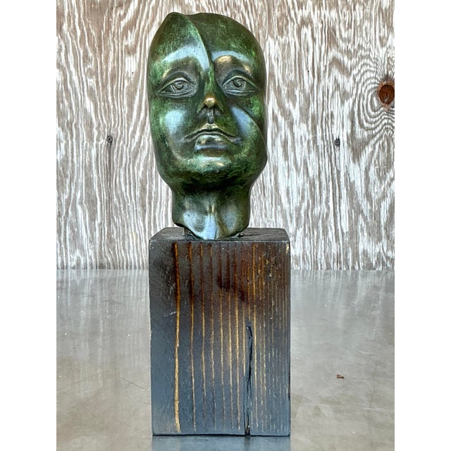 Discover the compelling beauty of abstract form with this vintage bronze sculpture depicting a woman's head. Crafted from...