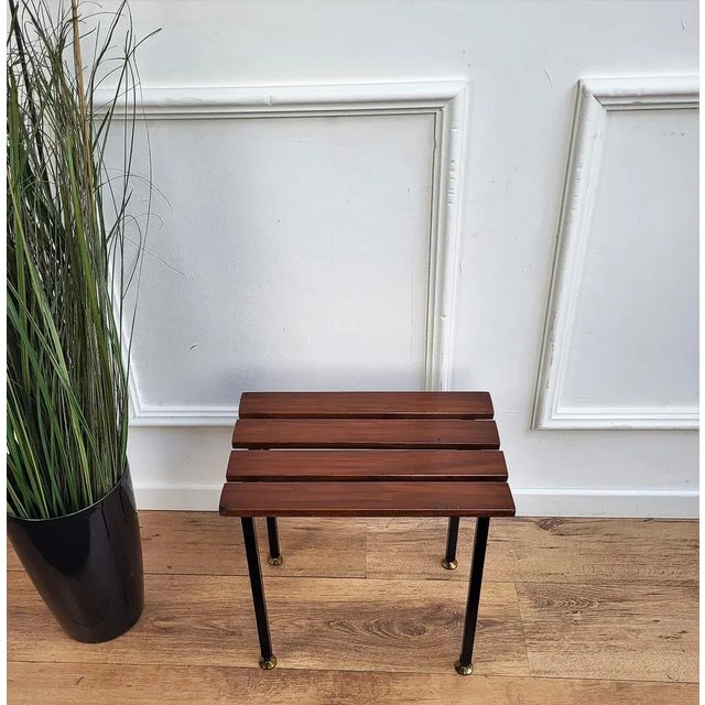 Italian Mid-Century Modern platform slat bench stool with wood slated top sitting on black metal base and nice brass foot-...
