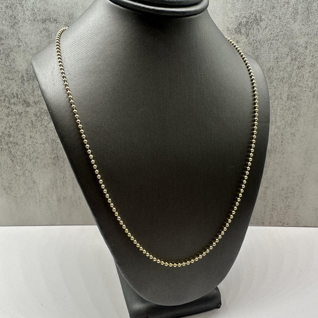 This classic 14kt yellow gold ball bead chain features a timeless, polished design that’s perfect for wearing alone or...