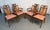 Beautiful set of eight mid-century modern dining chairs featuring sculpted walnut frames and floral upholstery. The warm...