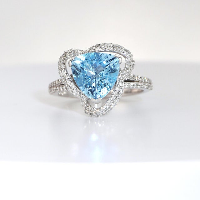 Radiant Elegance and Timeless Beauty. Set with a Trilliant-Cut Aquamarine. Accented by Round Brilliant-Cut Diamonds. 14K...