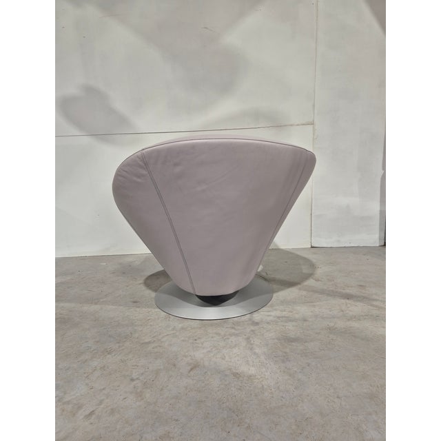 Beautiful eye catching design. This is a comfortable swivel chair in grey leather. This piece has an attribution mark, I...