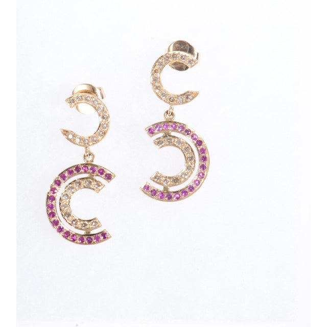 Our Diamond and Ruby Earrings are a timeless marriage of craftsmanship and contemporary elegance. Each earring contains 42...