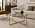 A sleek vintage round coffee table featuring a sunlit brass geometric metal frame and clear glass top. Clean-lined, airy,...