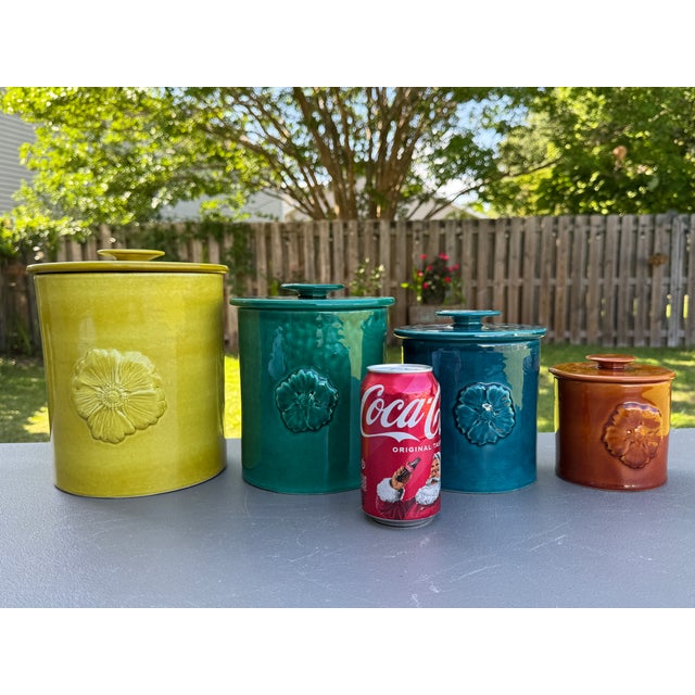 Offering for sale this positively gorgeous set of 4 lidded kitchen canisters with the following features: - Colors...