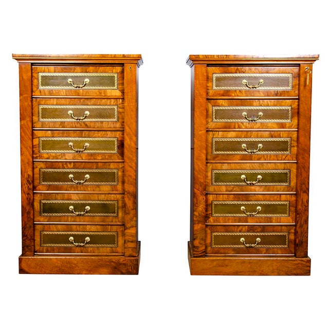 Each with squarish rectangular tops over six green tooled leather faced drawers with cast bail handles the whole with...
