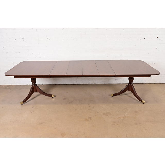 An exceptional Georgian or Regency style double pedestal extension dining table By Kindel Furniture USA, Circa 1980s...