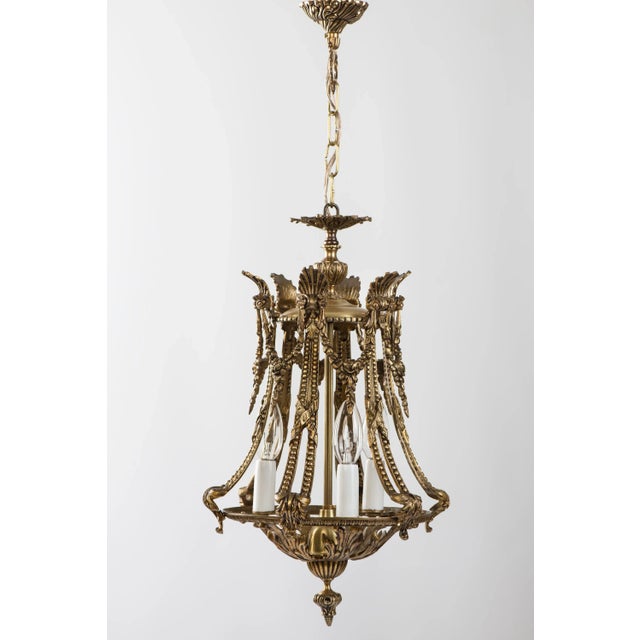 This light source features a frame-like shade in brass with floral motifs. Made in Spain. Circa 1950s. It has been...