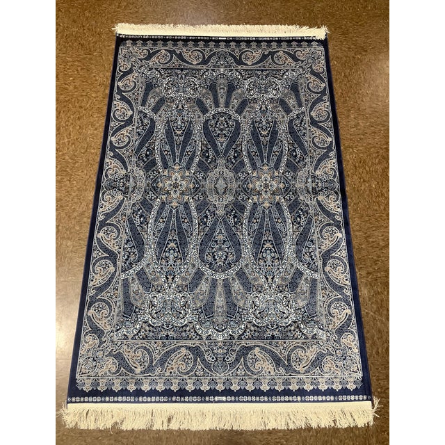 Machine-made Turkish wool rug featuring an intricate all-over floral and paisley-inspired design set on a deep navy...