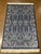 Machine-made Turkish wool rug featuring an intricate all-over floral and paisley-inspired design set on a deep navy...