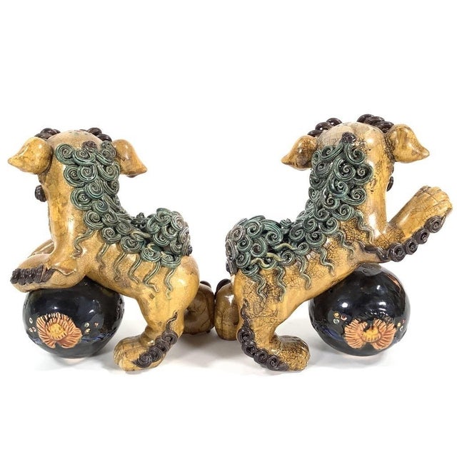 Great pair of mid-century polychrome glazed ceramic foo dogs from China, circa 1950s. Great detail and a beautiful color...