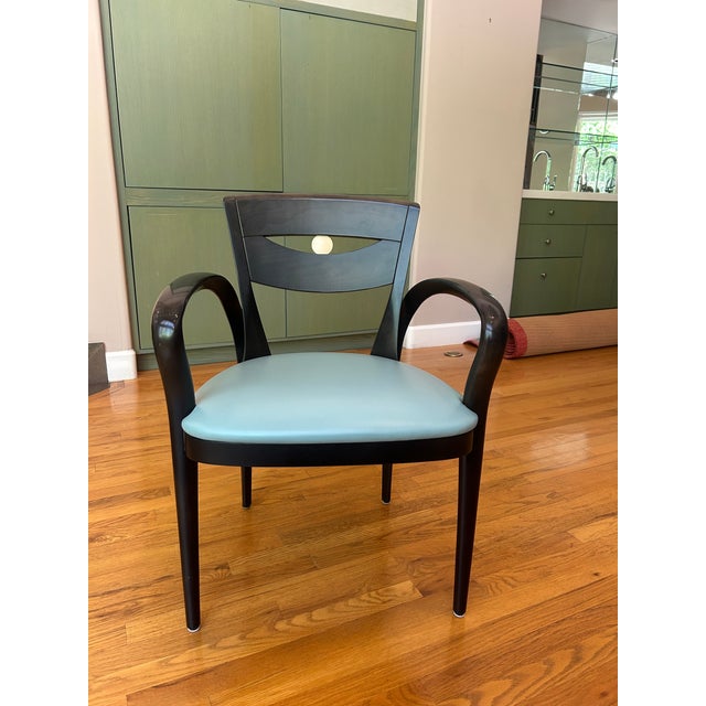 Crafted in solid beechwood with original leather upholstered seats, the DeTriana chair by Perry King & Santiago Miranda...
