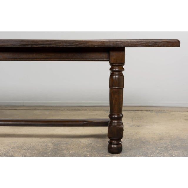 A substantial antique French refectory dining table in the Louis XIII style, sourced in Provence, France. Crafted in solid...