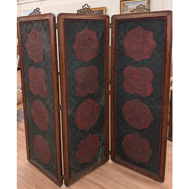 A chinese lacquer and hardwood folding scree. Three panels measuring 64 inches high, and 22 inches wide, total width is...