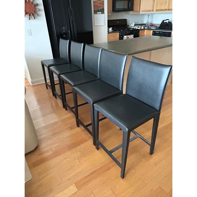 Set of 5 counter-height stools from Crate & Barrel, purchased approximately 20 years ago. Black faux leather upholstery...