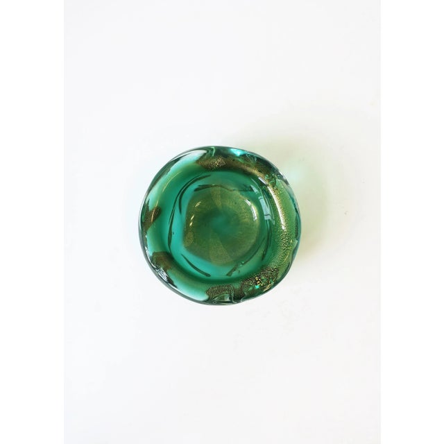 A beautiful and substantial Italian Murano bowl in an Emerald green and gold art glass, with soft edges in an organic...