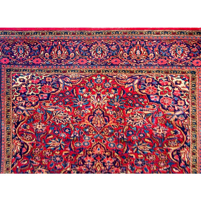 A gorgeous early 20th century Persian Kashan rug with an all-over pattern of myriad flowers and scrolling vines woven in...