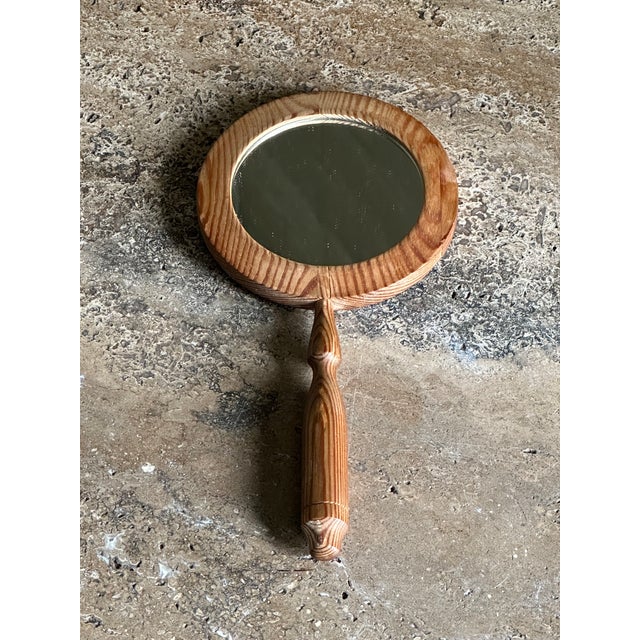 A small handled mirror in pine from Sweden circa 1970s. Great simple mirror executed in pine. Could be used as a...