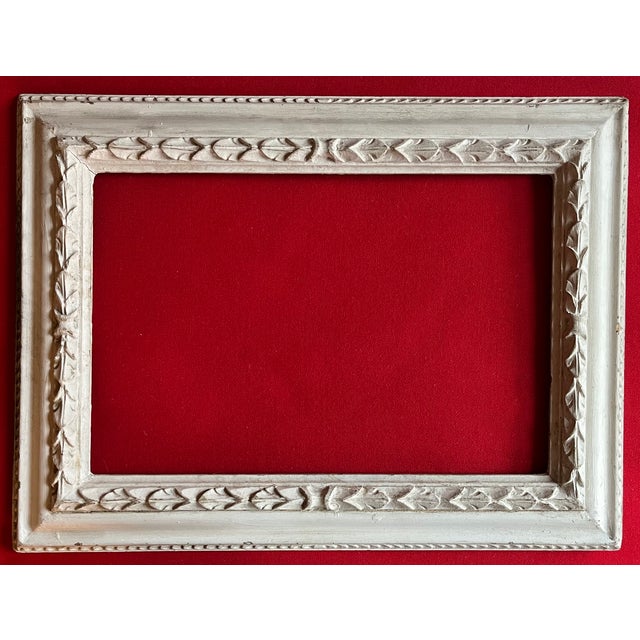 Eugene Roy "E.R." Witten (American 1920 - 2004) carved and white paint decorated wood picture frame in the Beaux Arts...
