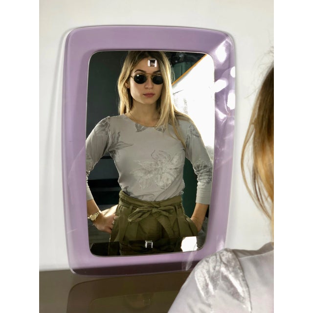 Italian wall mirror in rectangular shape featuring a violet acrylic frame, circa 1970.