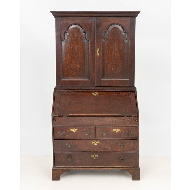 George III Oak Bureau Bookcase, the top half with two doors opening to divided interior with three drawers above slant...