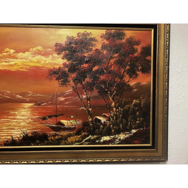 Scenic painting of lake, distant mountains in sunset with rich landscape detail. On canvas in original, deep gold painted...