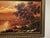 Scenic painting of lake, distant mountains in sunset with rich landscape detail. On canvas in original, deep gold painted...
