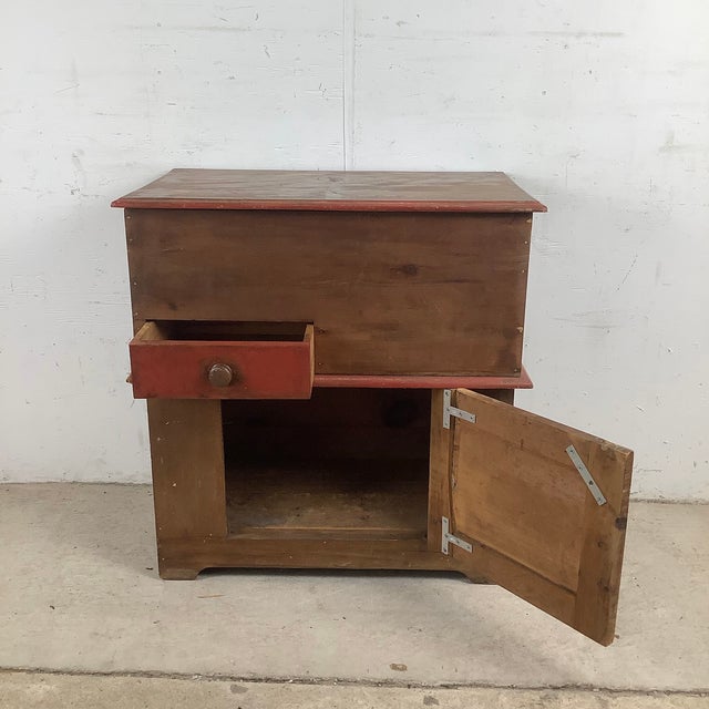 This antique American primitive painted pine cabinet celebrates the enduring appeal of early country craftsmanship....
