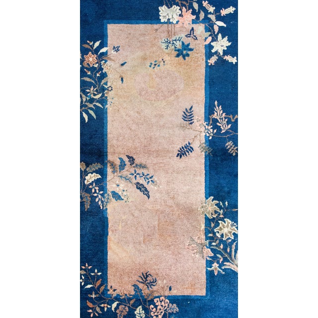 This early 20th-century Chinese Art Deco rug exudes timeless elegance and symbolic beauty. The cream central field creates...
