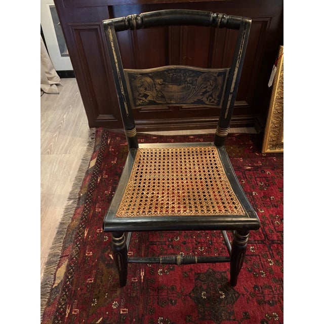 Charming antique farmhouse side or desk chair in the classic Hitchcock tradition, featuring an ebonized black wood frame...