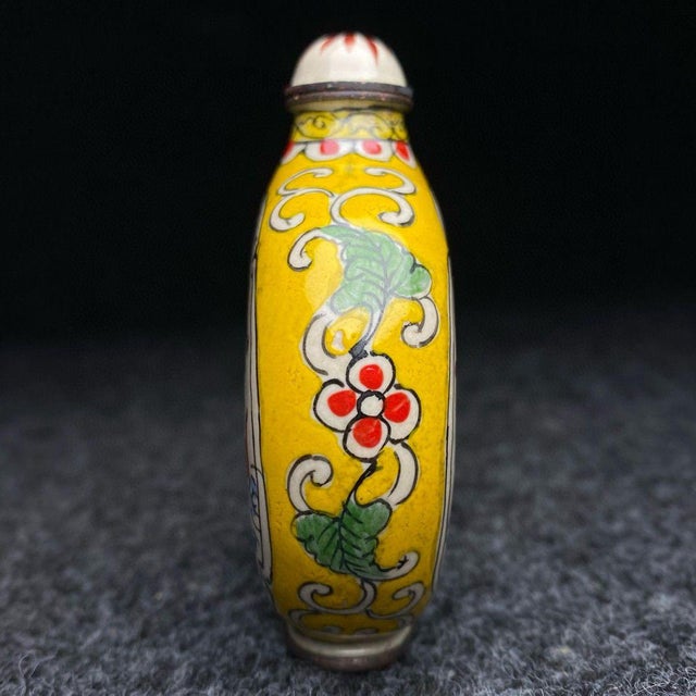 This striking vintage snuff bottle is a beautiful example of cloisonné enamel craftsmanship. The flattened, flask-shaped...