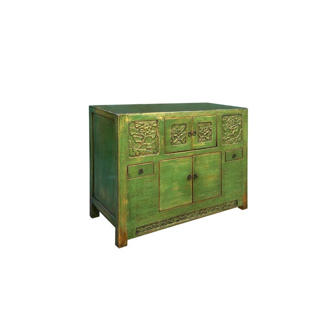 This antique green cabinet exudes a rustic charm, showcasing a weathered patina that hints at its rich history. Crafted...