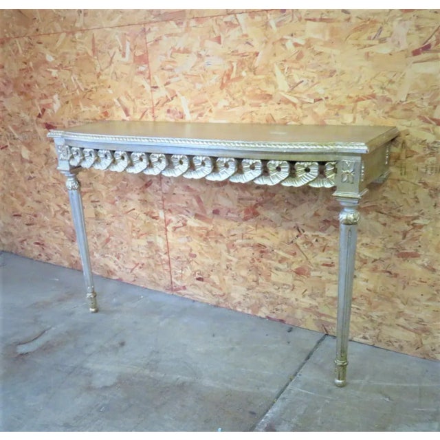 Silver gilt Florentine console table with ribbon carved skirt.
