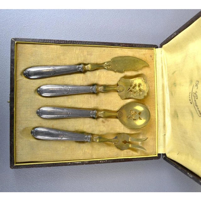 A set of cutlery for the center of the table. Silver handles, gold-plated scoops Minerva Trial, France. Decoratively...
