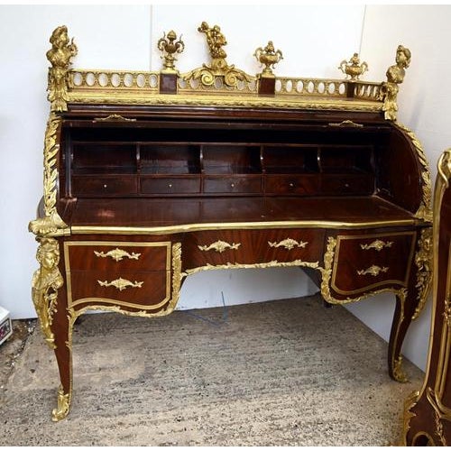 A very decorative French Louis XV style bureau à cylindre, finished in richly figured mahogany veneers and mounted...