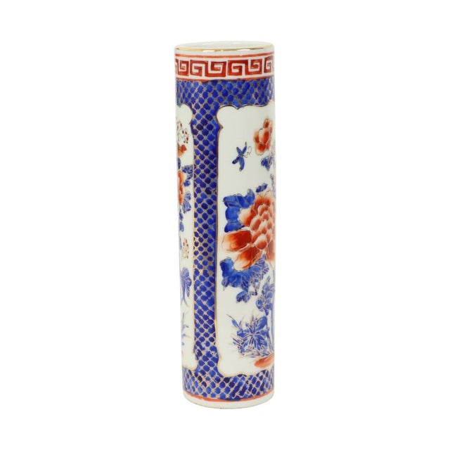 Small cylindrical vase made of porcelain with a colorful floral scene, elaborately decorated with patterns and floral...