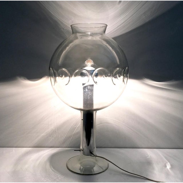 Made in Italy, 1970s. It features a steel stem and a spheric Murano glass shade. It is a vintage piece, therefore it might...