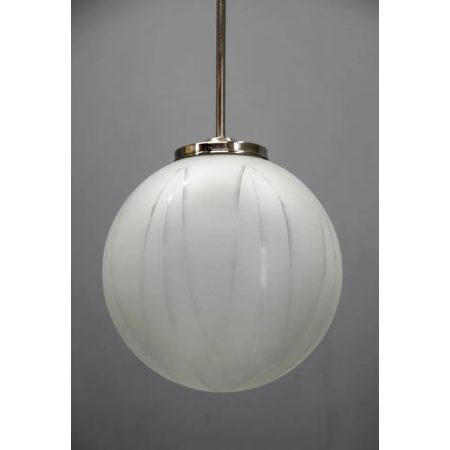 Rare huge glass Art Deco pendant with sandblasted geometrical pattern. Made in Europe in 1930s Long nickel rod polished,...