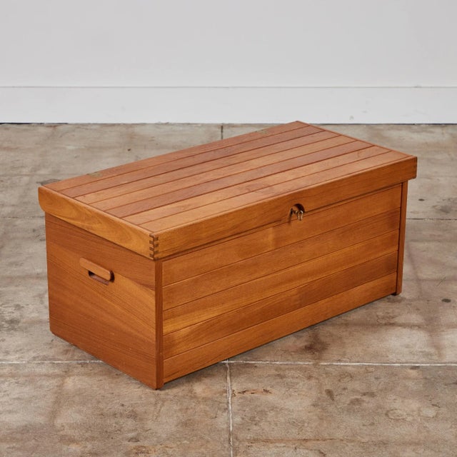Storage trunk by Kai Kristiansen for Aksel Kjersgaard, c.1960s, Denmark. The teak chest features a brass hinged lid and...