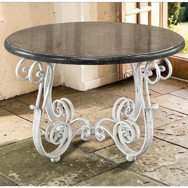 Antique French Painted Wrought Iron Round Coffee Table with Black Marble was crafted by an obviously talented and inspired...