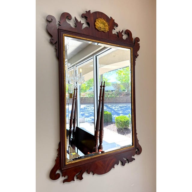 Elegant Henkel Harris Model H-6 wall mirror crafted in rich mahogany with classic Chippendale-inspired styling. Features a...