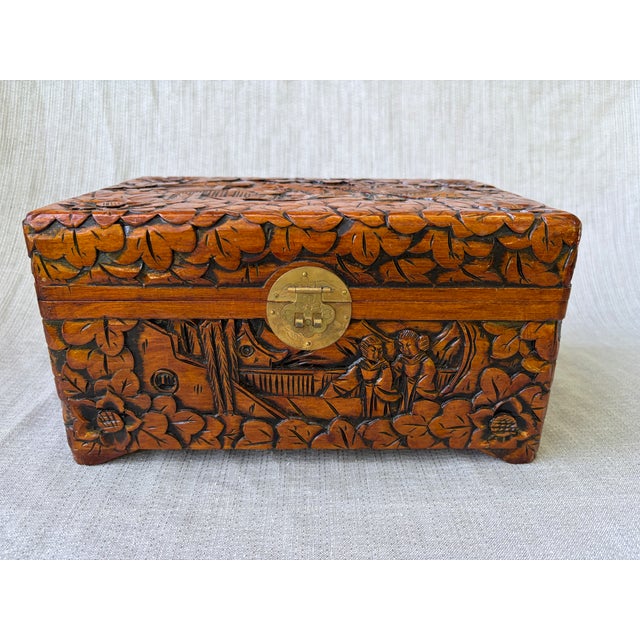 Intricately hand carved vintage camphor wood Chinese chest box, lined in deep, rich pink velveteen fabric. Round etched...