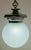 Attractive antique hanging opaline glass globe and cast metal pendant. The opaline globe has a subtle fishnet pattern and...
