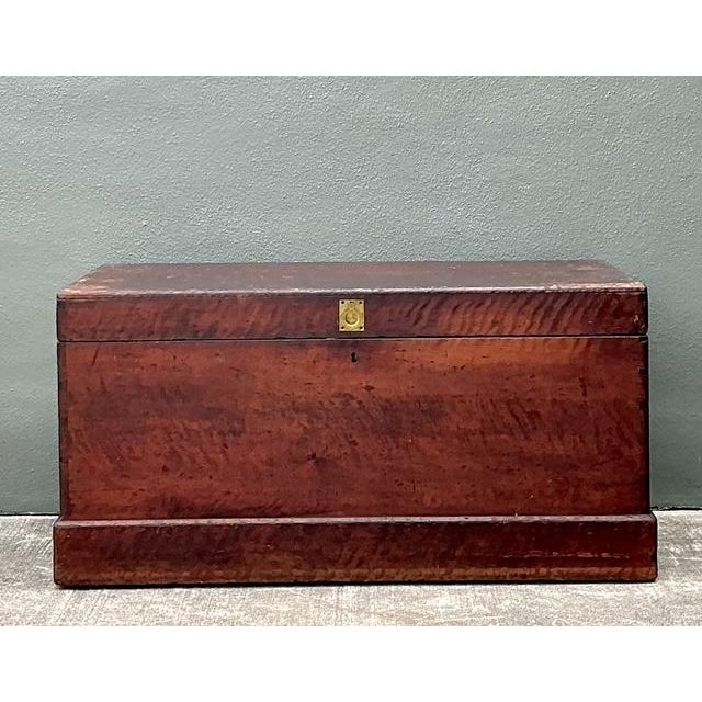 This magnificent 19th-century storage trunk is a soulful example of early Americana craftsmanship. The exterior is...
