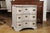 A Danish serpentine front three-drawer painted wood commode from the mid 18th century with pull-out shelf. This three-...